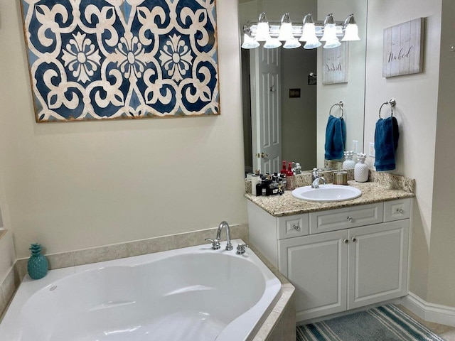 bathroom featuring a relaxing tiled tub and vanity