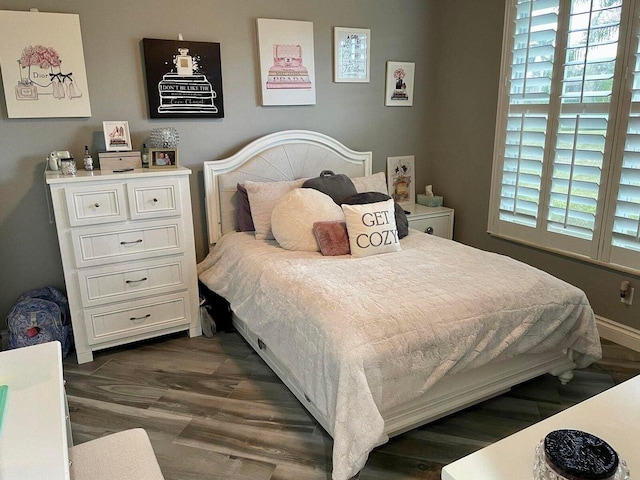 bedroom with dark hardwood / wood-style floors