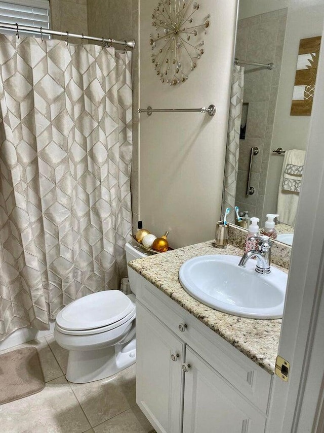 bathroom with toilet, tile patterned flooring, vanity, and curtained shower