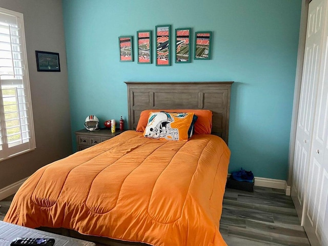 bedroom featuring a closet and dark hardwood / wood-style flooring