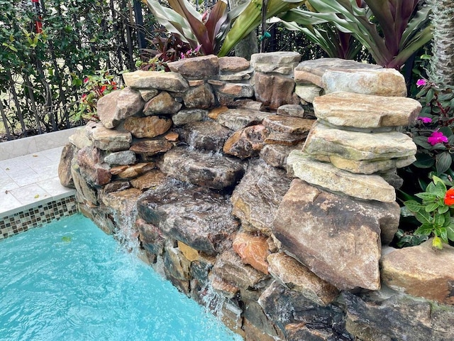 exterior details with a swimming pool