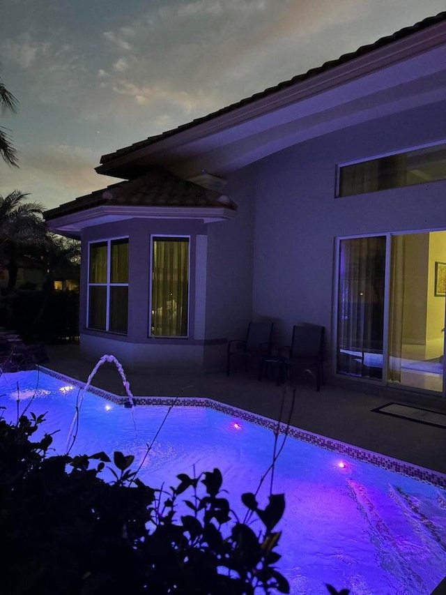 view of swimming pool with a patio area and pool water feature