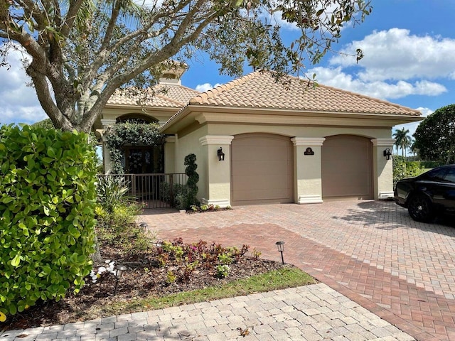 mediterranean / spanish-style house with a garage