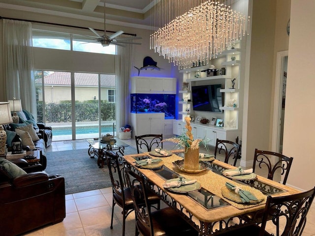 dining room with a high ceiling, ceiling fan, coffered ceiling, ornamental molding, and light tile patterned floors