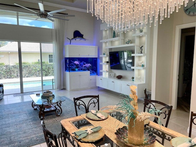 living room featuring a high ceiling, light tile patterned floors, and ceiling fan