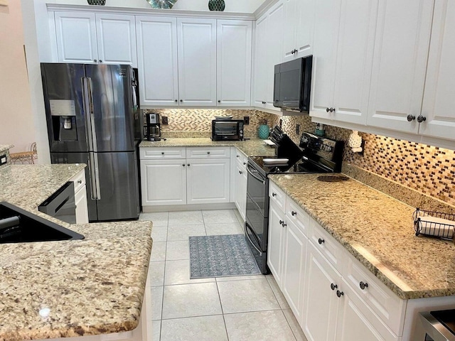 kitchen featuring light stone counters, white cabinets, light tile patterned flooring, tasteful backsplash, and black appliances