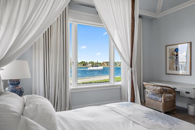 bedroom featuring crown molding, a water view, and hardwood / wood-style floors