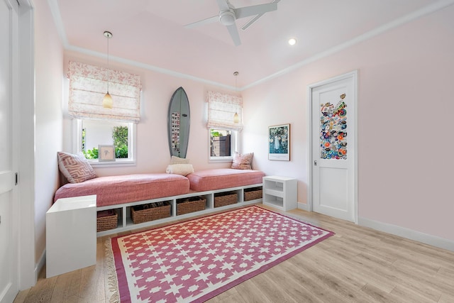 living area featuring ceiling fan, crown molding, and hardwood / wood-style flooring