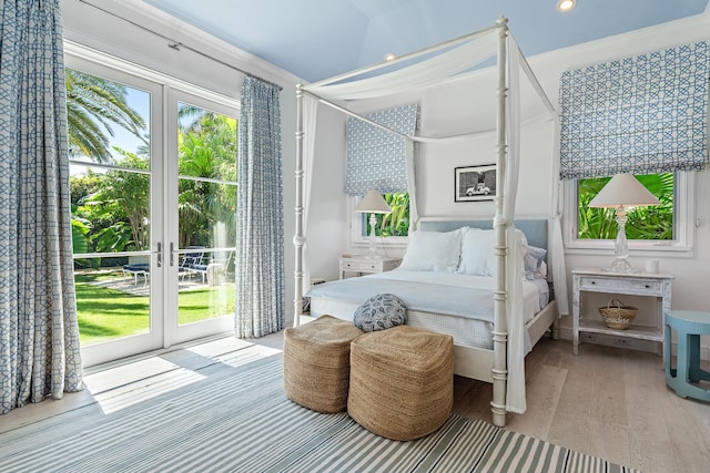 bedroom featuring french doors, access to exterior, crown molding, and light hardwood / wood-style flooring