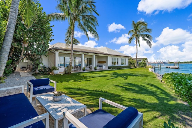 exterior space with a yard, a water view, and a patio