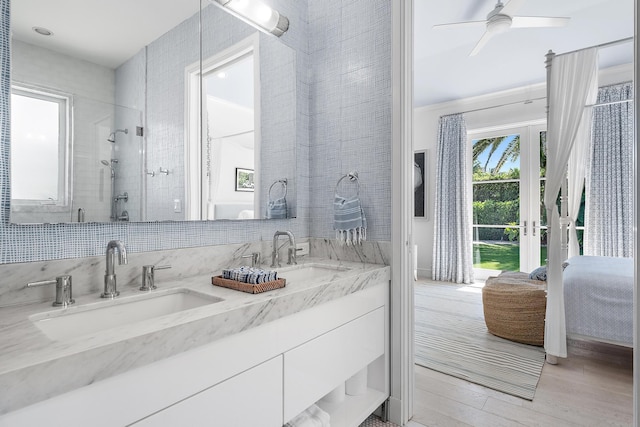 bathroom with a shower with door, hardwood / wood-style floors, vanity, and ceiling fan