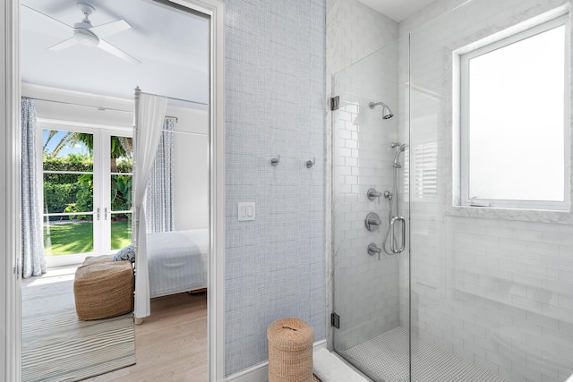 bathroom with ceiling fan, hardwood / wood-style flooring, and an enclosed shower