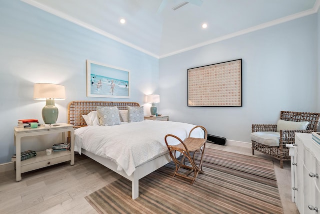 bedroom featuring vaulted ceiling, crown molding, and light hardwood / wood-style flooring