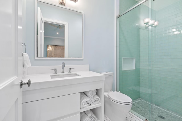 bathroom featuring toilet, vanity, and an enclosed shower