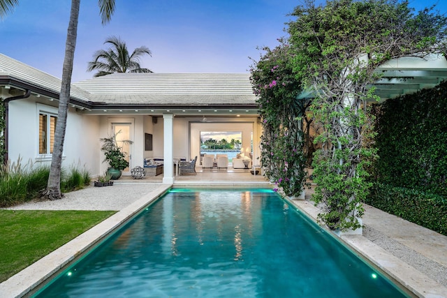 view of swimming pool featuring an outdoor living space and a patio area