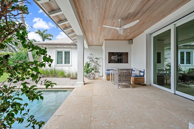 view of patio / terrace featuring ceiling fan and a swimming pool