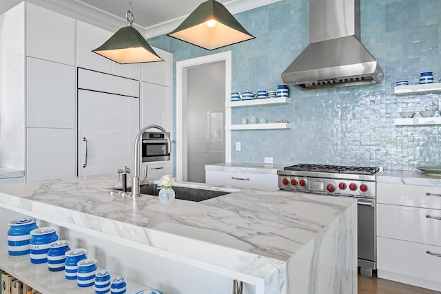 kitchen featuring stainless steel range with gas cooktop, crown molding, white cabinets, wall chimney exhaust hood, and light stone counters