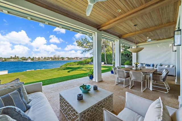 view of patio / terrace with ceiling fan, outdoor lounge area, and a water view