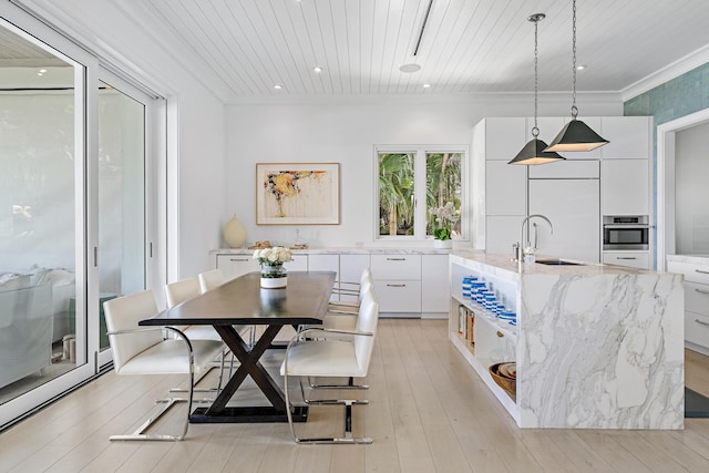 dining area featuring wood ceiling, sink, ornamental molding, and light hardwood / wood-style flooring