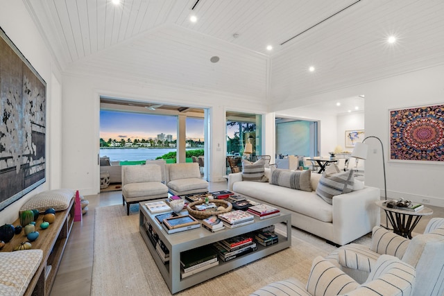 living room featuring high vaulted ceiling, light wood-type flooring, wood ceiling, and a water view