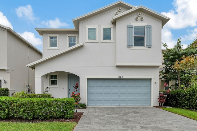 view of front of property with a garage and stucco siding