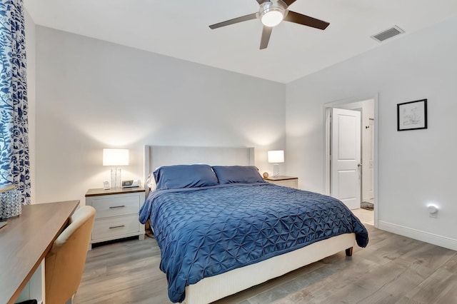 bedroom featuring baseboards, visible vents, ceiling fan, and light wood-style floors
