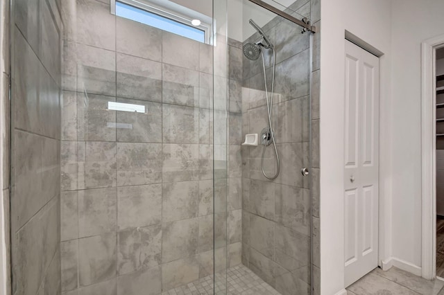 bathroom with a closet and a stall shower