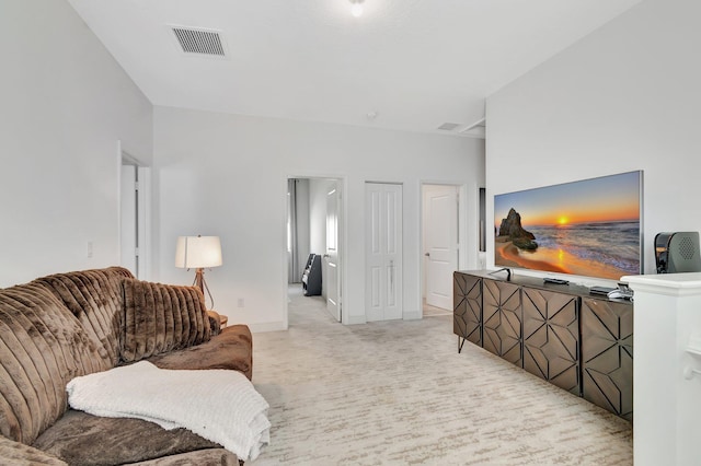 living area featuring baseboards, light colored carpet, and visible vents