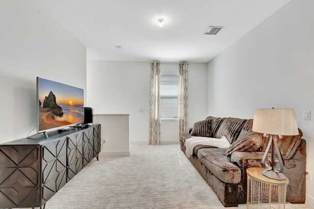 carpeted living room featuring baseboards and visible vents