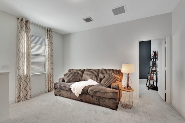 living area with visible vents, carpet, and baseboards