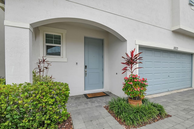 property entrance with stucco siding