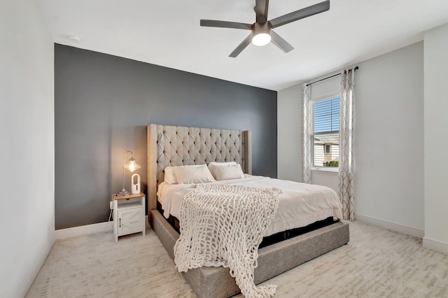 bedroom with baseboards, light carpet, and ceiling fan