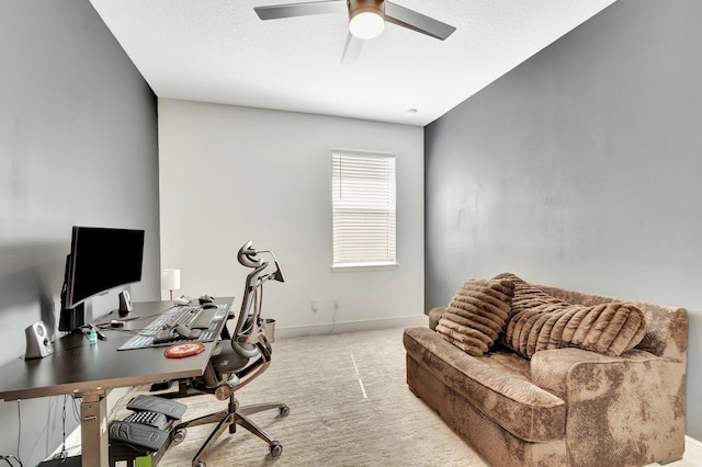 office area featuring baseboards, light colored carpet, and ceiling fan