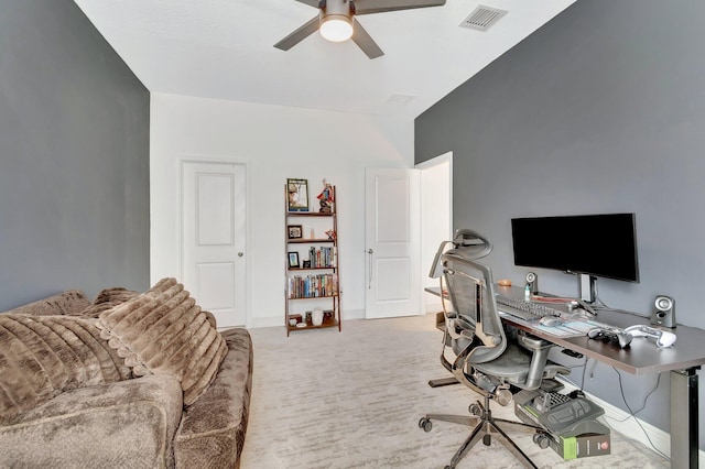 home office with a ceiling fan, baseboards, visible vents, and light carpet