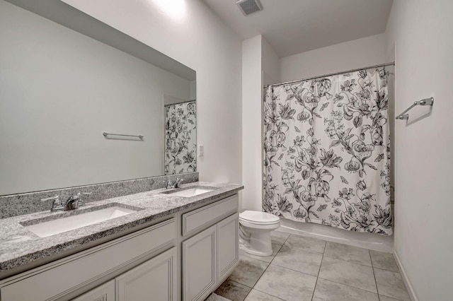 full bath with a sink, toilet, double vanity, and visible vents
