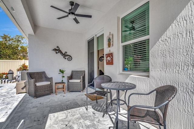 view of patio / terrace featuring a ceiling fan and fence