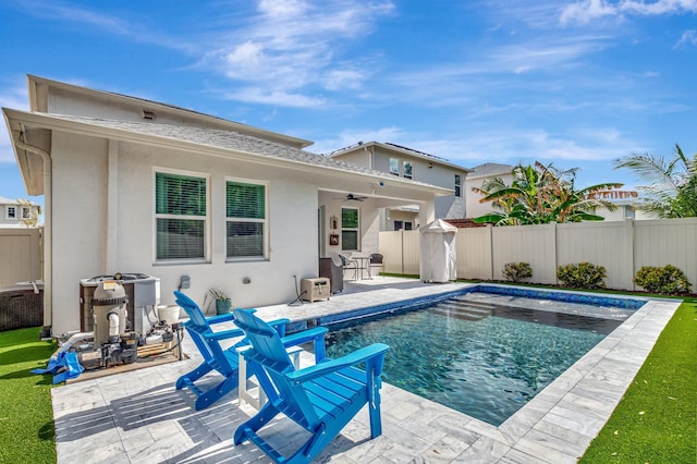 back of property featuring a patio, a fenced backyard, stucco siding, a fenced in pool, and a ceiling fan