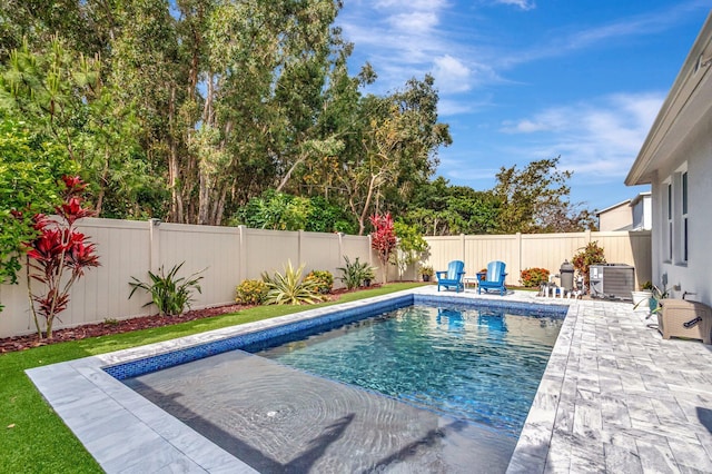 view of swimming pool with a patio, a fenced backyard, central AC, and a fenced in pool