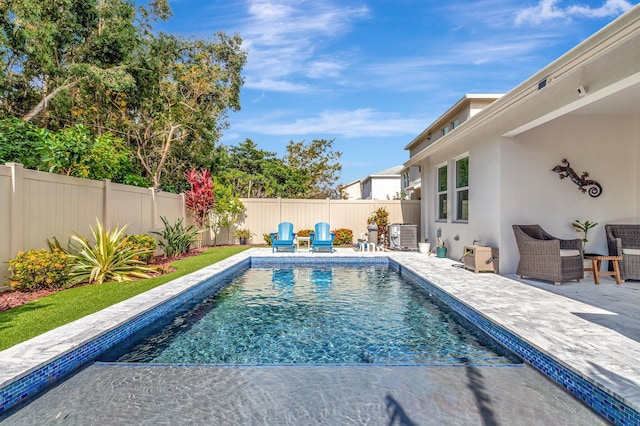 view of pool featuring a patio, central AC, a fenced in pool, and a fenced backyard