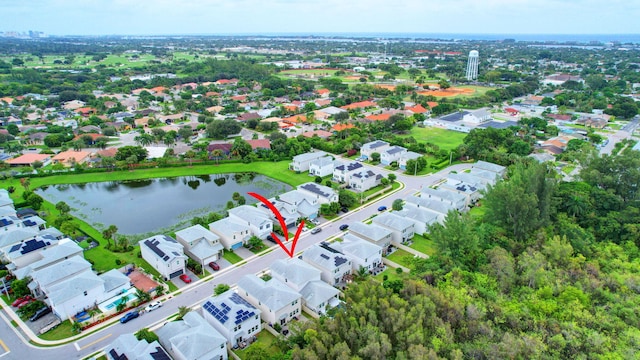 drone / aerial view with a water view and a residential view