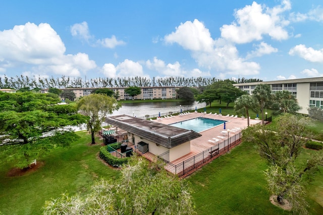 view of swimming pool featuring a water view and a yard