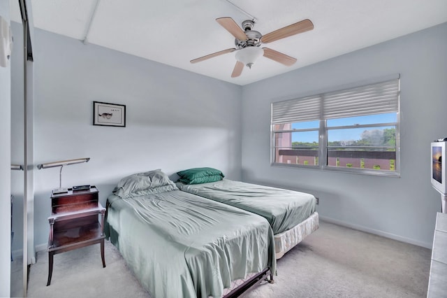 bedroom with ceiling fan and light colored carpet