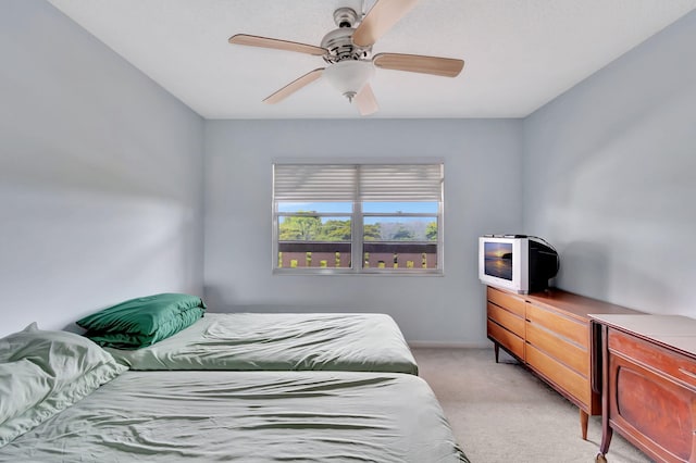 bedroom with light carpet and ceiling fan