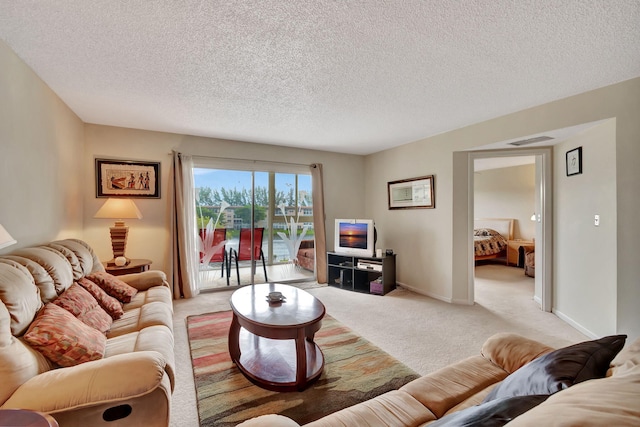 living room featuring a textured ceiling and light carpet