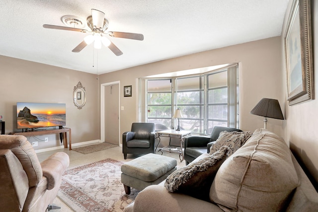 living room with a textured ceiling and ceiling fan