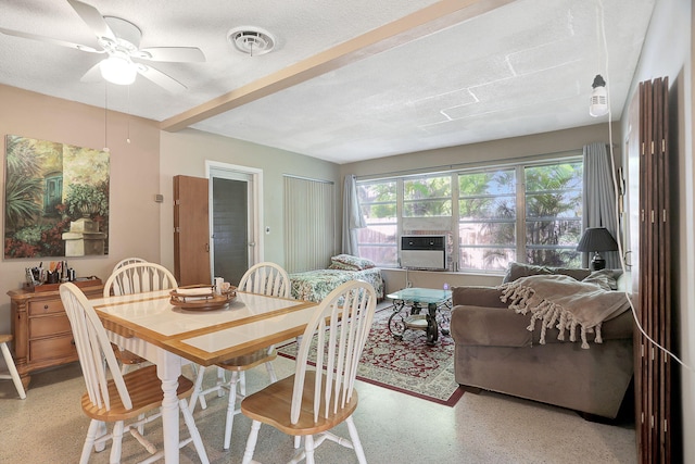 dining room with ceiling fan, cooling unit, and a textured ceiling