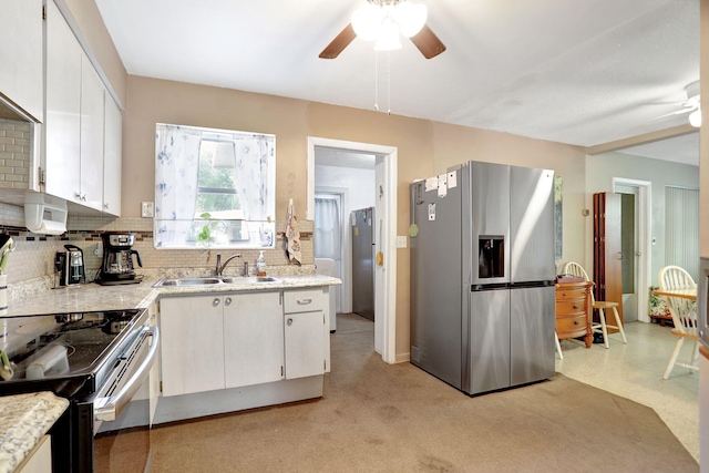 kitchen with stainless steel appliances, backsplash, white cabinets, and sink