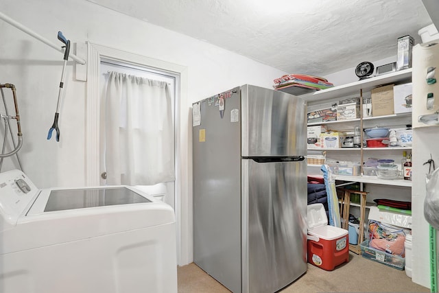 clothes washing area featuring a textured ceiling and light carpet