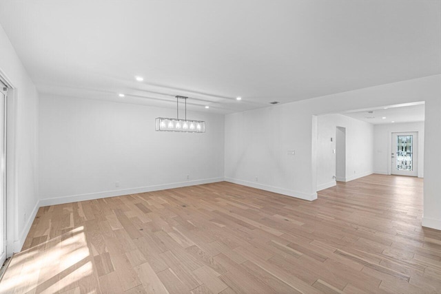 spare room featuring light hardwood / wood-style flooring