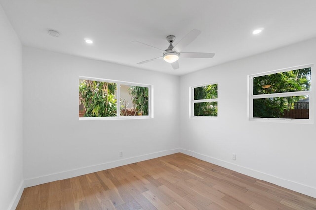 spare room with ceiling fan, plenty of natural light, and light hardwood / wood-style floors